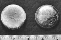 Plutonium pictured against an inch and centimeter rule.